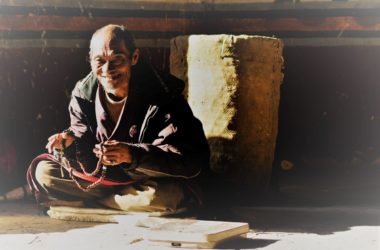 Elderly people with prayer wheel